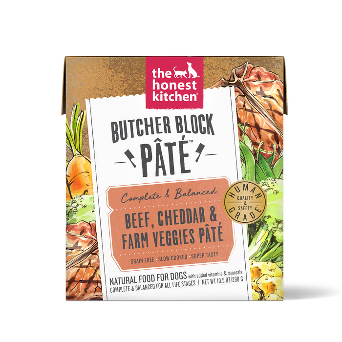 A box of The Honest Kitchen Butcher Block Pâté dog food in beef, cheddar, and farm veggies flavor. The packaging is decorated with illustrations of vegetables and meat and highlights that it is human grade and grain free.
