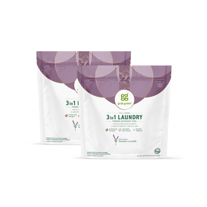 Two bags of grab green 3 in 1 Laundry Detergent Pods - Lavender with Vanilla are shown upright, displaying their purple and white packaging with product details visible on the front.