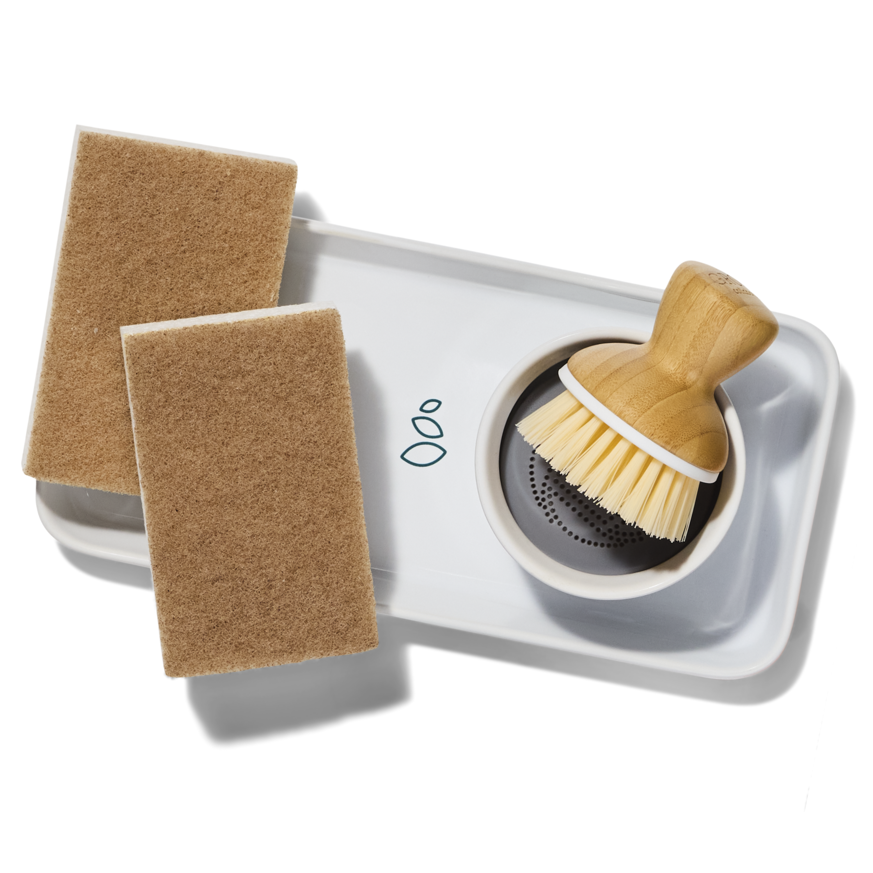 Image shows Grove Co. ceramic tray, bubble up scrubber, and two walnut scrubber sponges.