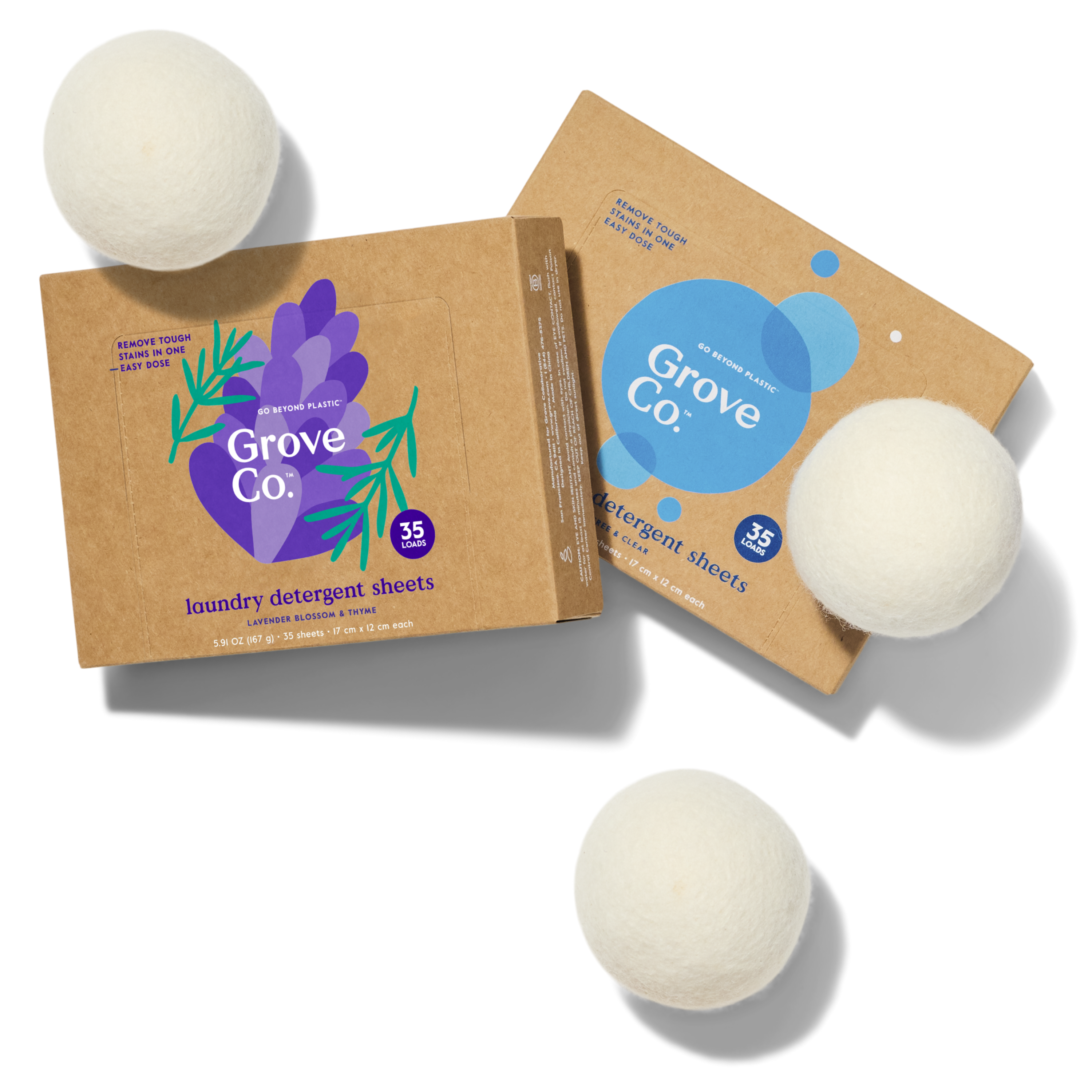 Grove Co. laundry detergent sheets in Free & Clear and Lavender Blossom & Thyme. Image also shows wool dryer balls.