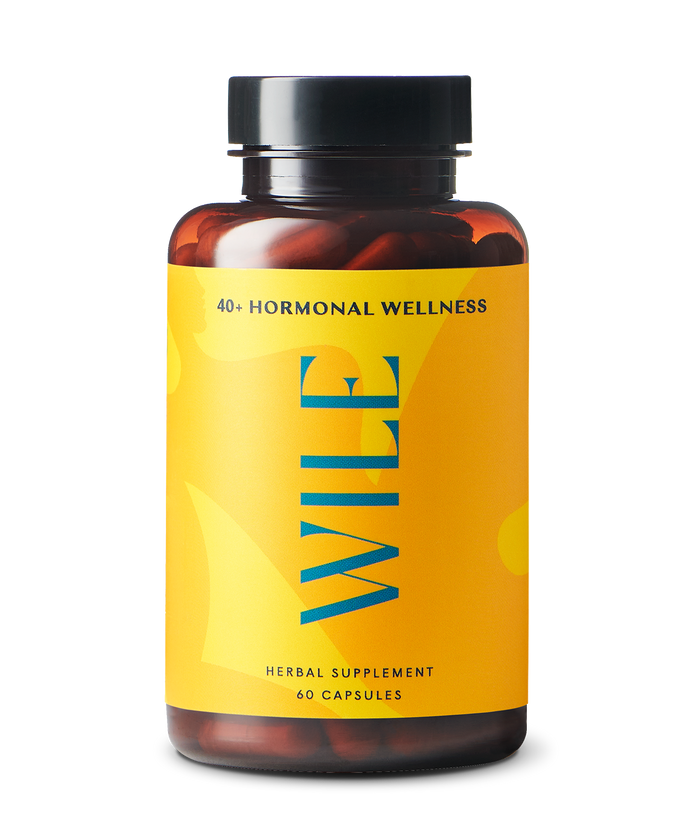 A bottle of Wile Herbal Supplement for hormonal wellness, featuring a bright yellow label with blue text and containing 60 capsules. The label indicates it is designed for people 40 and over.