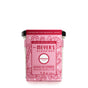 The limited edition pink Mrs. Meyers Soy Glass Jar Candle features a peppermint scent and candy cane design. Made from vegetable soy wax, its cruelty-free, weighs 7.2 oz (204 g), and offers 35 hours of burn time.