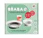 A mint green BEABA box displays a baby glass meal set with suction pads, showing a bowl, plate, and cup. The packaging includes text in French and English, and a French flag indicating its made in France.