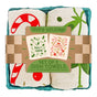 The Neighborgoods Dish Towel Set of 2 - Happy Holidays features festive cotton towels with candy cane and mistletoe designs, rolled in a box adorned with illustrated holiday cards—an ideal kitchen gift for the season.