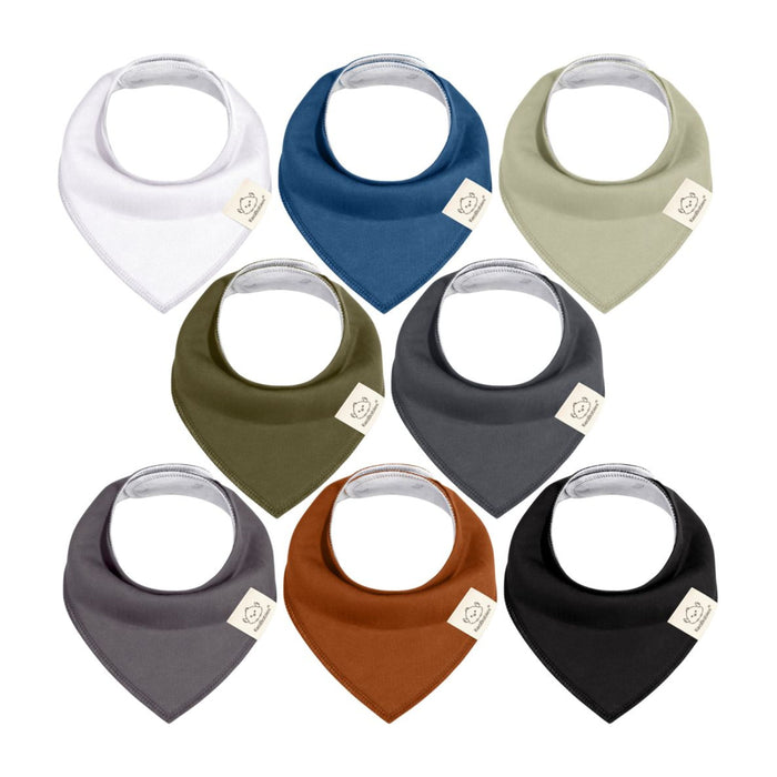 Eight baby bandana bibs arranged in two rows, each in a different solid color: white, navy blue, light olive, olive green, charcoal, dark gray, rust, and black. Each bib features a small tag on the corner.