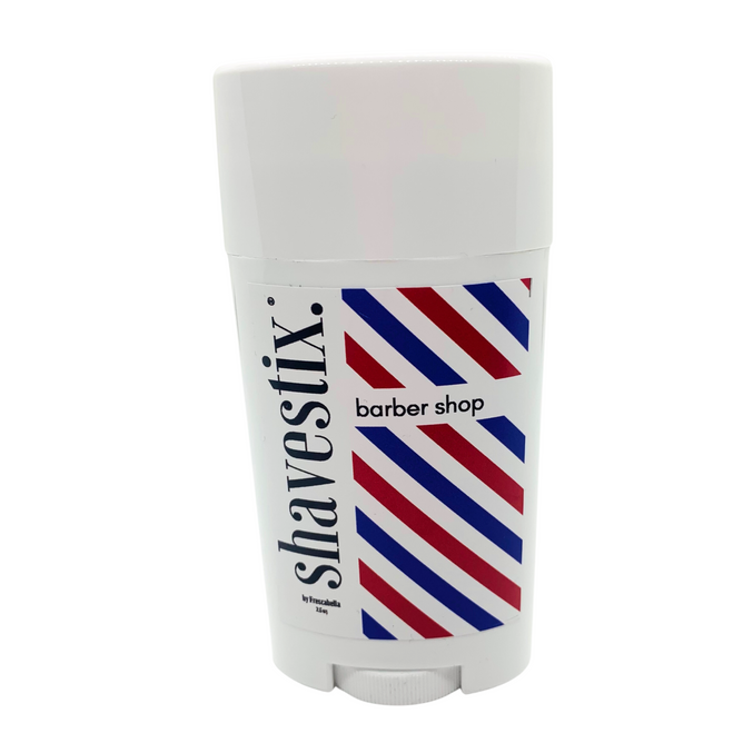 The Solid Shave Stick by Shavestix comes in a travel-friendly white container, adorned with red, blue, and white barbers pole stripes. This aftershave balm hydrates and refreshes your skin.