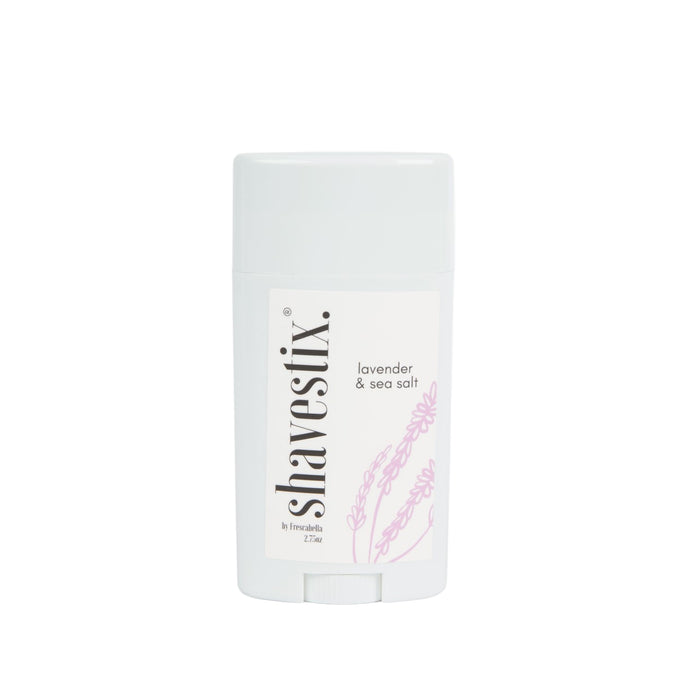 A pale blue Solid Shave Stick labeled Shavestix, featuring lavender & sea salt. A subtle lavender illustration graces the design, hinting at its hydrating veil by Humble.