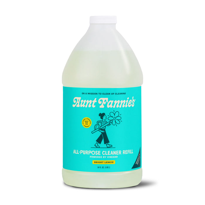 A plastic jug of Aunt Fannie’s All-Purpose Cleaner Refill in Bright Lemon scent, featuring a turquoise label with a cartoon of a person holding flowers and product information in white and yellow text.