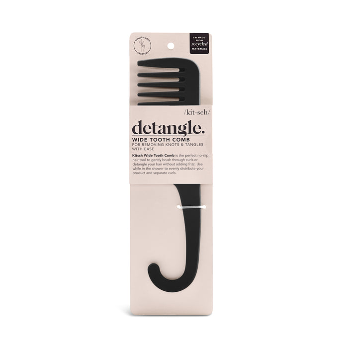 A black wide tooth comb with a hook handle is packaged on a beige card labeled detangle by Kitsch, designed for removing knots and tangles from hair.