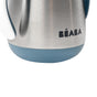 Close-up of the bottom half of a stainless steel container with a blue base and the brand name BÉABA printed on it in black lettering.