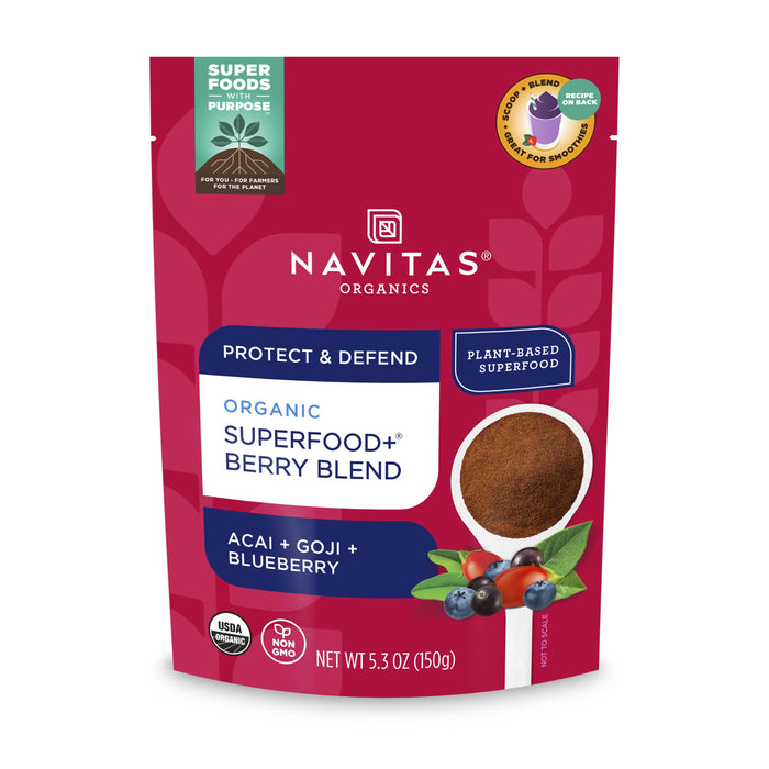 A red and white packet of Navitas Organics Superfood+ Berry Blend, labeled as organic and plant-based, with images of acai, goji berries, and blueberries on the front. The net weight is 5.3 oz (150g).