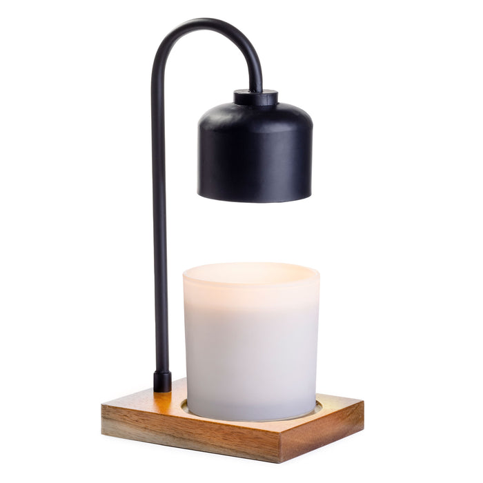 A candle warmer lamp with a black curved metal arm, a black lampshade, a white frosted glass candle, and a square wooden base.