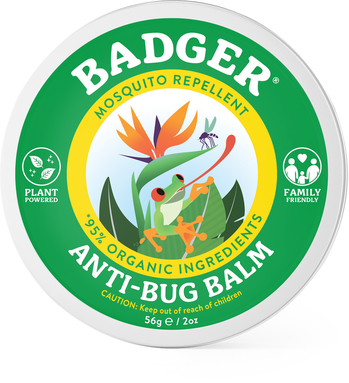 Round tin of Badger Anti-Bug Balm with a green, white, and yellow label featuring a person swatting a mosquito, surrounded by plants. Text highlights mosquito repellent and 95% organic ingredients.