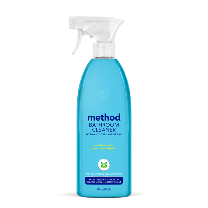 A bottle of Method Bathroom Cleaner with a spray nozzle, featuring blue liquid and labeled “eucalyptus mint” scent. The label highlights plant-based cleaning power and mildew stain removal.