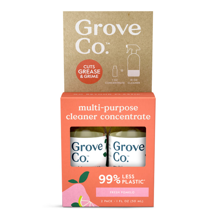 A package of Grove Co. multi-purpose cleaner concentrate in the fresh pomelo scent. The pack highlights 99% less plastic and contains two 1 fl oz bottles. The packaging is pink and brown with citrus illustrations.