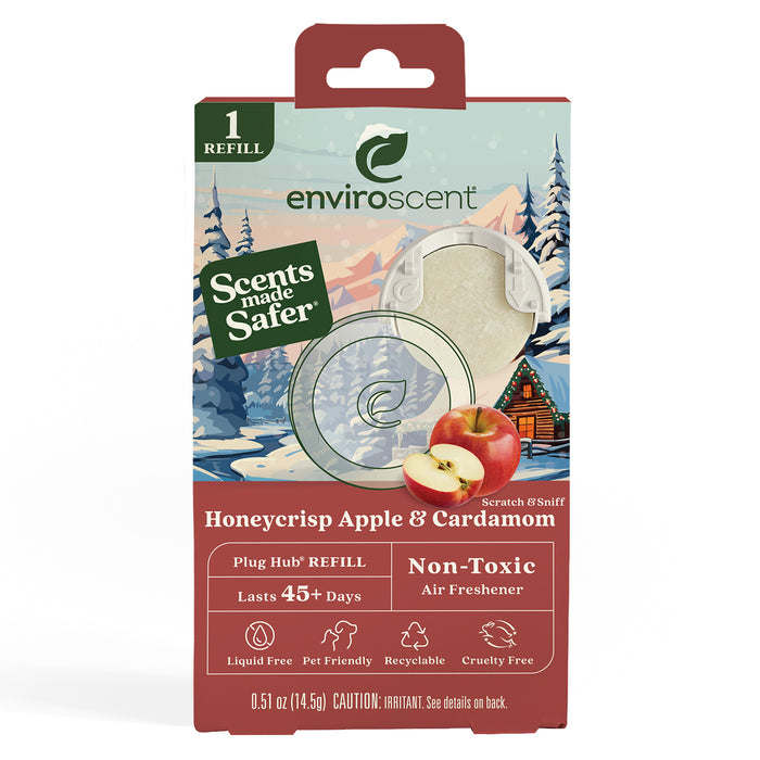 EnviroScent Plug Hub refill packaging with snowy winter landscape, apple, and cardamom illustrations. Text highlights: Honeycrisp Apple & Cardamom scent, lasts 45+ days, non-toxic, cruelty-free, and recyclable.