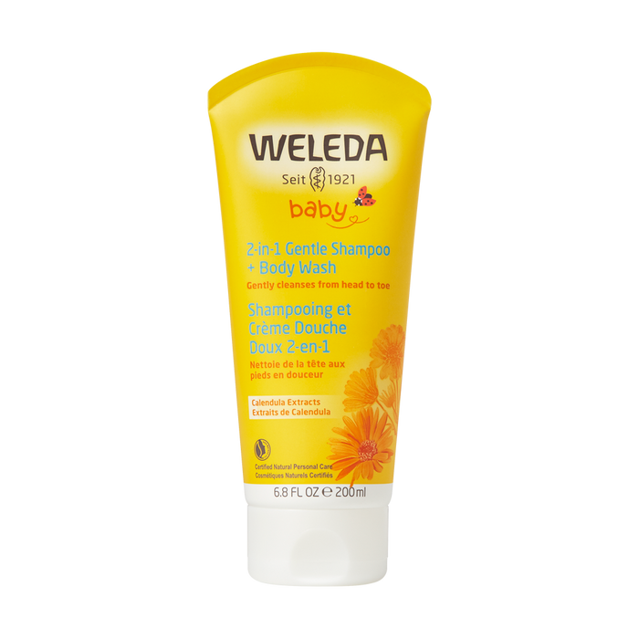 A yellow 6.8 fl oz tube of Weleda Baby 2-in-1 Gentle Shampoo & Body Wash with calendula extracts, featuring orange flowers and bilingual English-French text on the front.