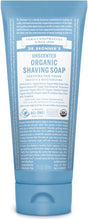 Dr. Bronners Organic Shaving Soap, in a 7 fl oz (207 mL) blue tube, boasts Certified Fair Trade and Smooth & Moisturizing qualities. Crafted by family soapmakers since 1858, it highlights its dedication to organic ingredients.