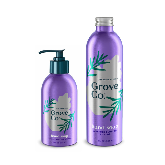 The Refillable Hand Soap Starter Set by Grove Co.™ includes two lavender bottles: a pump dispenser in lavender blossom & thyme scent and a larger refill with a cap, both adorned with green leaf graphics emphasizing their plant-based ingredients.