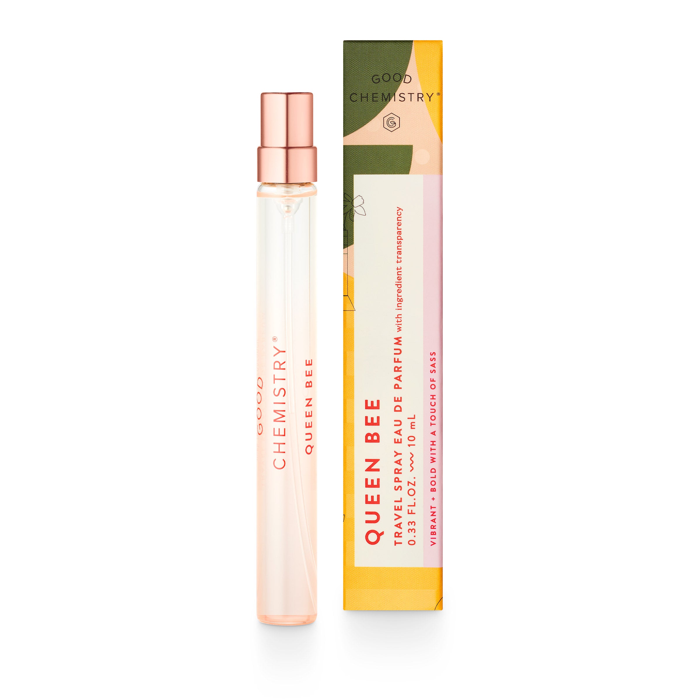 A slender bottle of Good Chemistry Eau De Parfum Travel Spray sits beside its colorful box, exuding elegance. The cruelty-free perfume boasts floral and abstract designs. The transparent bottle with a pink-gold spray top contains a delightful vegan fragrance.
