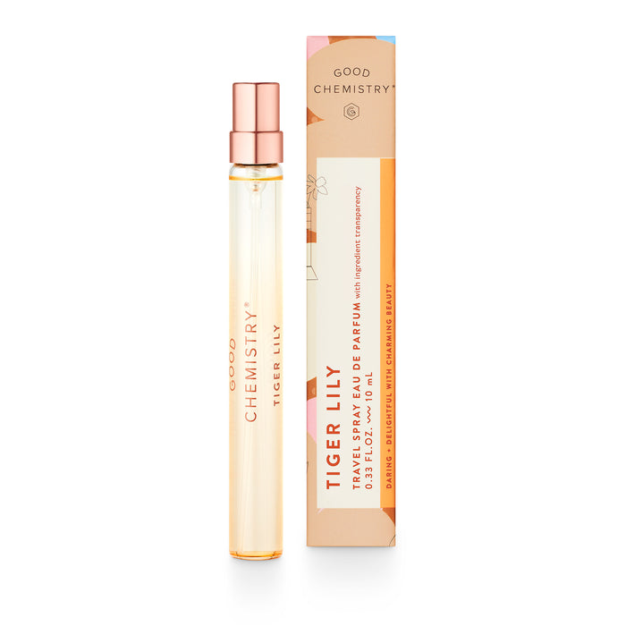 A slender glass perfume spray bottle labeled Good Chemistry Tiger Lily stands next to its colorful rectangular box, which is peach, orange, and pink with white text and gold accents.