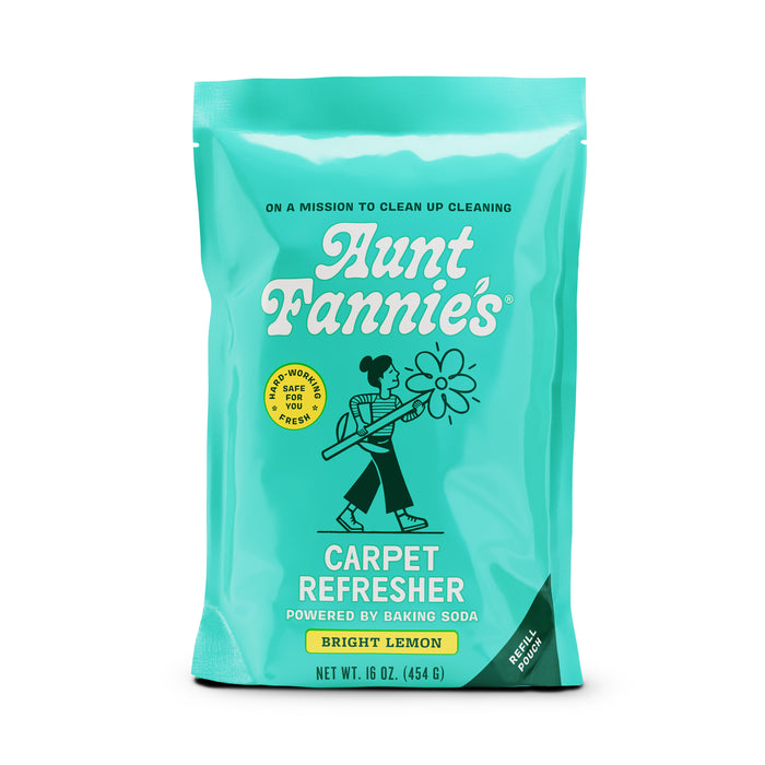 A turquoise bag of Aunt Fannies Carpet Refresher, Bright Lemon scent, featuring an illustration of a woman vacuuming, with text stating its powered by baking soda and safe for people and pets. Net weight: 16 oz (454 g).