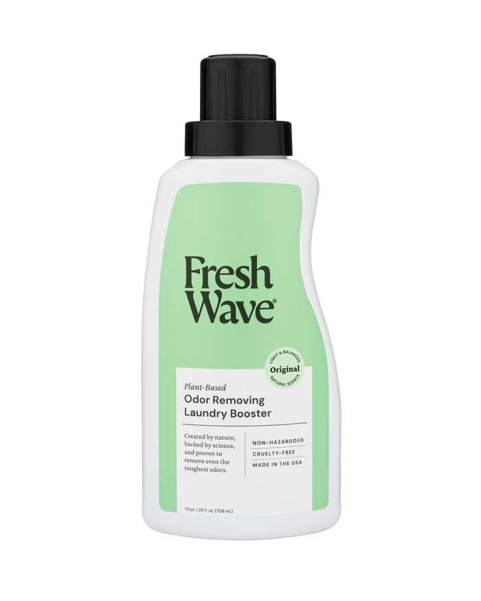 A white bottle of Fresh Wave Odor Removing Laundry Booster with a green label and black cap. The label highlights that it is plant-based, cruelty-free, non-hazardous, and made in the USA.