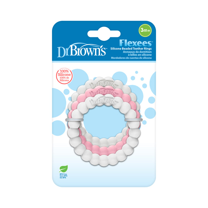 Dr. Brown’s Flexees silicone beaded teether rings in white and pink are shown in their packaging, suitable for babies aged 3 months and up. The packaging features blue and white colors and product details.