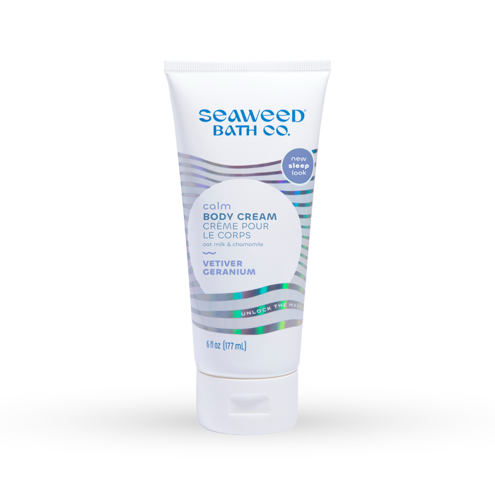 A tube of Seaweed Bath Co. Calm Body Cream in Vetiver Geranium scent, featuring a white and blue design with text detailing its soothing properties and a flip-top cap. The tube contains 6 fl oz (177 mL).