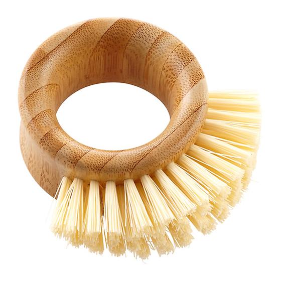 A round bamboo dish brush with a hollow center and stiff, light-colored bristles arranged along one side for scrubbing.