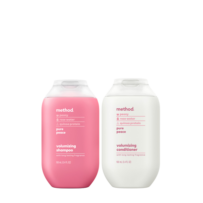 The Shampoo + Conditioner Set - Travel Size by method includes a pink volumizing shampoo and a white conditioner, both infused with peony and rose water. Labeled pure peace, these 10 oz bottles provide a long-lasting fragrance, ideal for on-the-go serene styling.