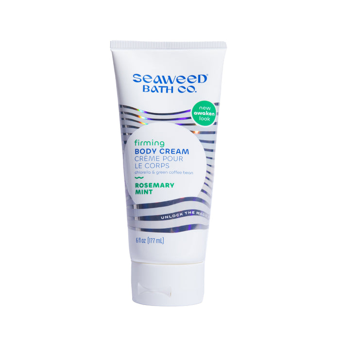 A white tube of Seaweed Bath Co. Firming Body Cream in Rosemary Mint scent, featuring teal, blue, and gray accents, and labeled with new awaken look and unlock the magic. The tube size is 6 fl oz (177 mL).