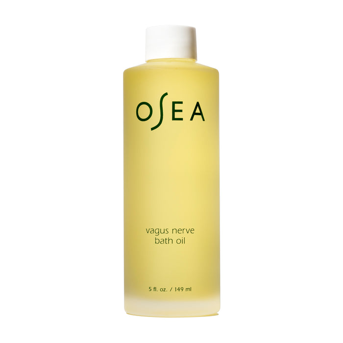 The 5 fl. oz. OSEA Vagus Nerve Bath Oil, ideal for relaxation, comes in a translucent bottle showcasing its yellow-tinted essence, with OSEA and Vagus Nerve Bath Oil on the label for serene bath moments.