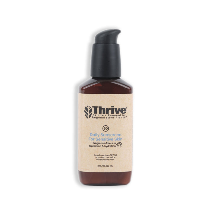 A brown bottle of Thrive Daily Sunscreen for Sensitive Skin SPF 30 with a pump dispenser and a beige label, photographed on a white background.