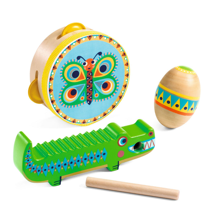 A set of colorful wooden musical toys, including a tambourine with a butterfly design, a maraca with geometric patterns, and a green crocodile-shaped guiro with a wooden stick.