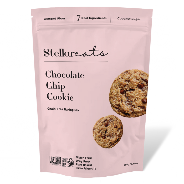 A pink bag of Stellareats Chocolate Chip Cookie baking mix featuring images of two cookies. The packaging highlights key features: gluten free, dairy free, plant based, paleo friendly, and contains 7 ingredients.