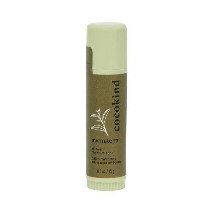 A green tube of Cocokind mymatcha all-over moisture stick, featuring a minimalist label with a leaf illustration and text describing it as a hydrating balm, 0.5 oz (15 g).