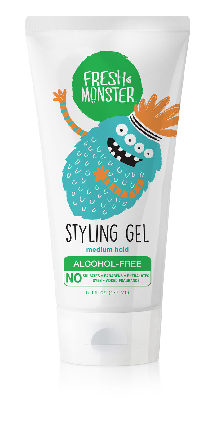 A white tube of Fresh Monster Styling Gel features a blue cartoon monster with orange hair, waving. The label highlights Medium Hold, Alcohol-Free, and states No sulfates, parabens, phthalates, dyes, added fragrance.
