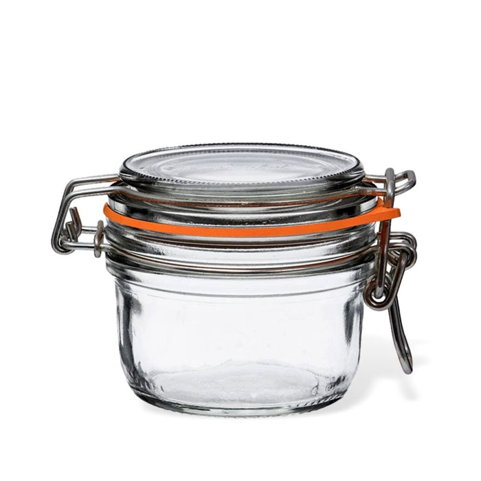 A small, empty glass jar with a metal clasp lid and an orange rubber seal, designed for airtight storage, is shown against a white background.