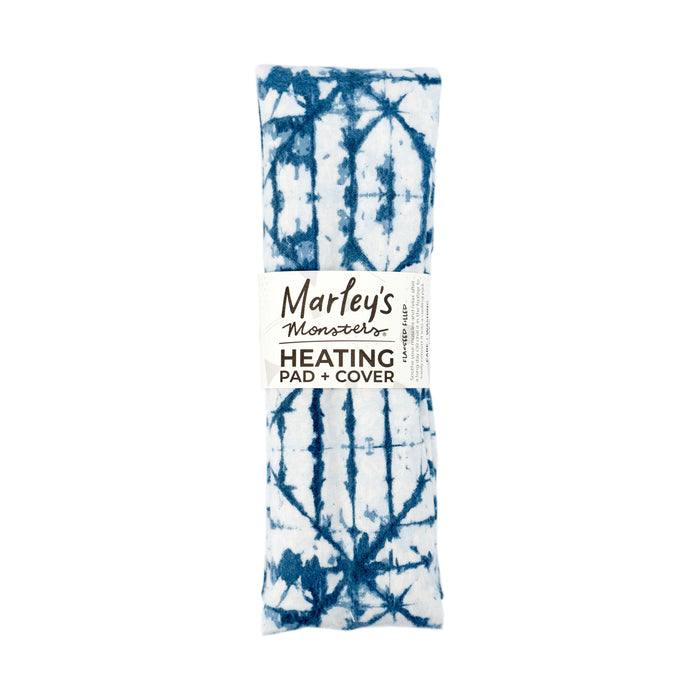 A rectangular blue and white tie-dye heating pad with a label that reads Marley’s Monsters Heating Pad + Cover. The pad is neatly rolled and photographed against a white background.