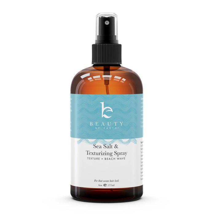 A brown spray bottle labeled Beauty by Earth Sea Salt & Texturizing Spray with a black pump and a blue and white label, designed for adding texture and beach waves to hair.