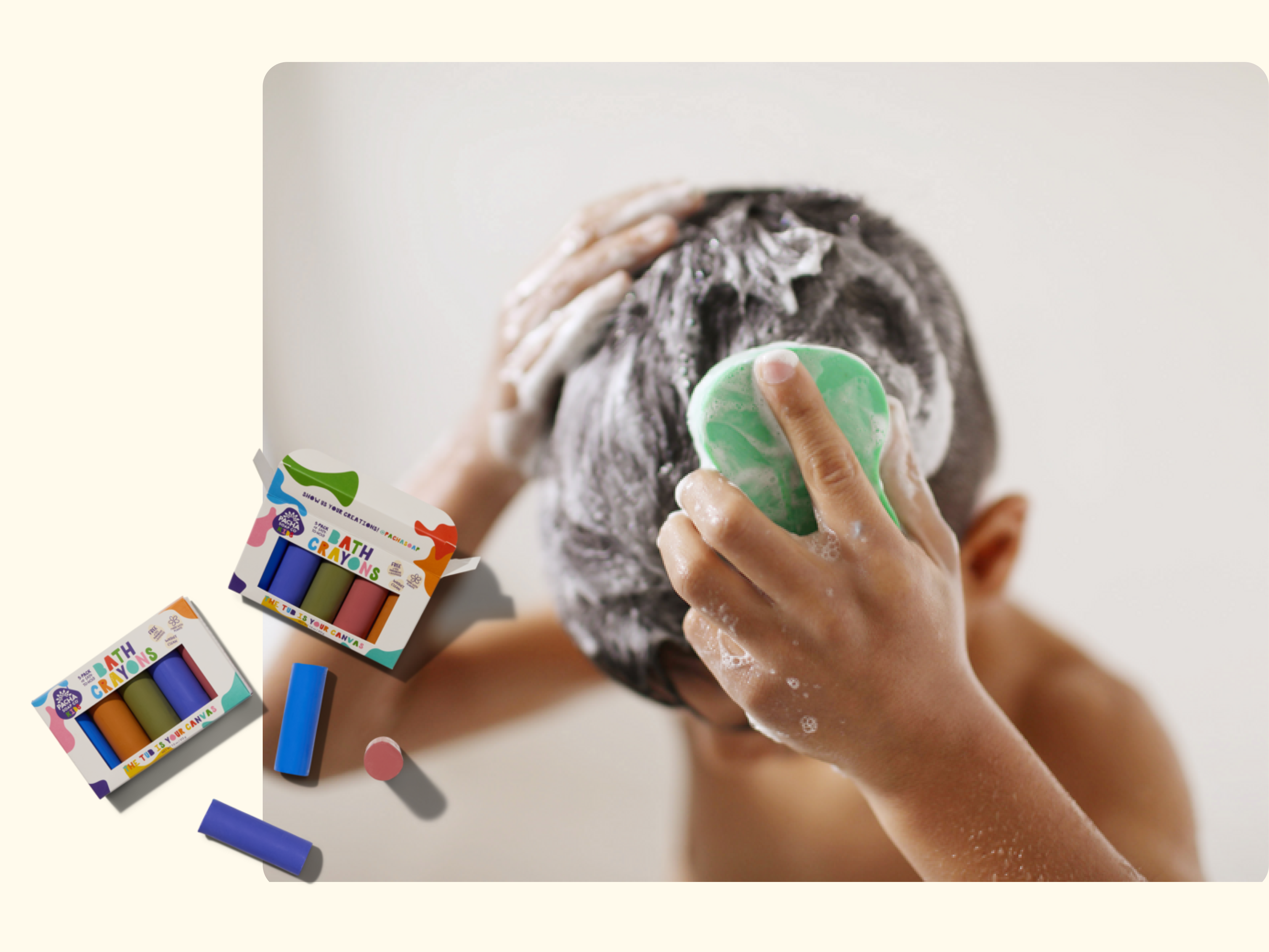 Child washing soapy hair while holding a green bar of soap, with two colorful Bath Crayons sets and loose crayon sticks displayed nearby.