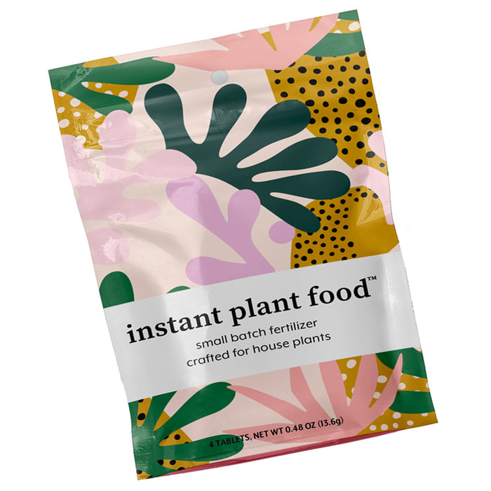 A colorful, patterned bag labeled instant plant food, small batch fertilizer crafted for house plants, containing 4 tablets with a net weight of 0.48 oz (13.6g).