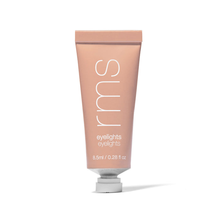 A peach-colored squeeze tube labeled rms eyelights with 8.5 ml / 0.28 fl oz on the front, standing upright with a white cap at the base.