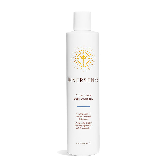 A white bottle of Innersense Quiet Calm Curl Control styling cream, featuring a gold sunburst logo and black text on the front. The bottle has a white cap and holds 10 fl oz (295 mL).
