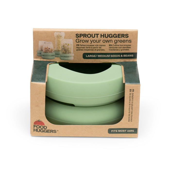 A package of Food Huggers Sprout Huggers, labeled Grow your own greens, containing two green silicone lids, designed to fit most jars for sprouting seeds and beans. Packaging is brown with green accents.
