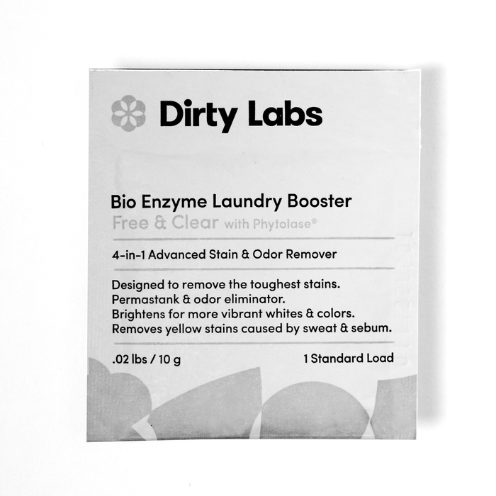 A Dirty Labs Bio Enzyme Laundry Booster sample packet, labeled as a 4-in-1 stain and odor remover for laundry, weighing 0.02 lbs (10 g) and designed for 1 standard load. The packet is mostly white with black and gray text.