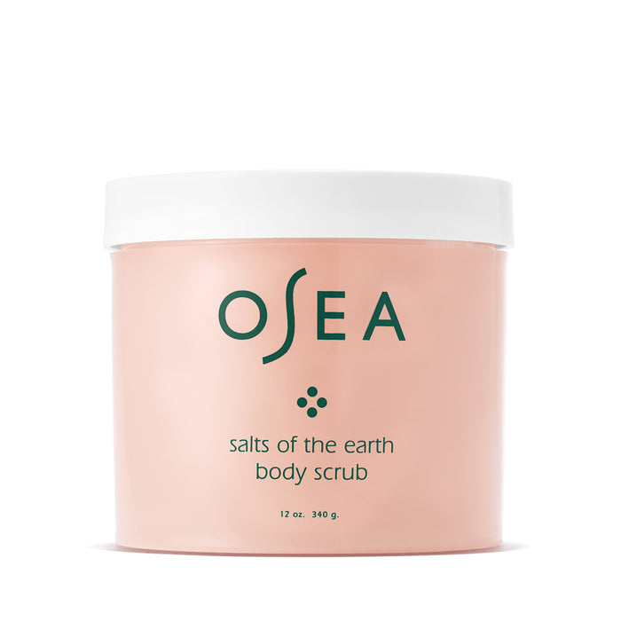 A 12 oz (340 g) pink container labeled Salts of the Earth Body Scrub by OSEA, featuring a white lid, holds skin-softening, mineral-rich salts.