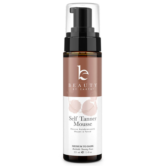 A bottle of Beauty by Earth Self Tanner Mousse, medium to dark shade, with a pump dispenser and a brown and white label featuring the brand logo and product details, containing 7.5 fl oz (221 ml).