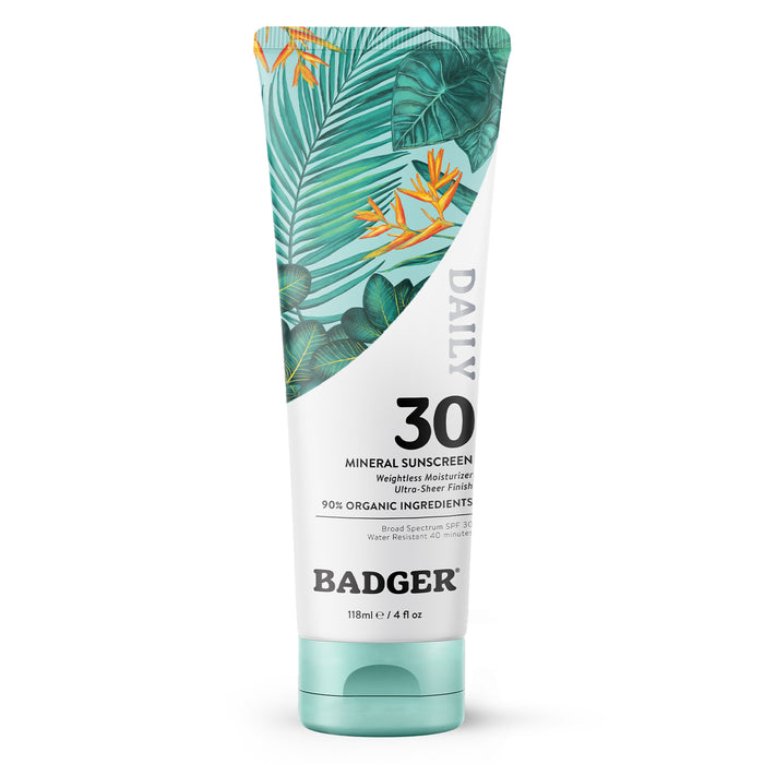A tube of Badger Daily Mineral Sunscreen SPF 30 with a tropical leaf design, labeled as containing 90% organic ingredients and 118ml (4 fl oz).